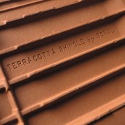 A close up view of the back of brown, line, material, metal, wood, wood stain, brown, orange, black