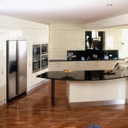 View of kitchen with black granite benchtops, stainless cabinetry, countertop, cuisine classique, floor, flooring, hardwood, interior design, kitchen, room, wood flooring, gray, brown