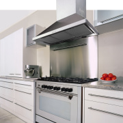 A view of a kitchen, polished concrete tiled countertop, home appliance, kitchen, kitchen appliance, kitchen stove, white