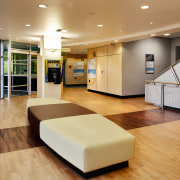 Lobby area of hospital with two toned flooring ceiling, floor, flooring, interior design, lobby, orange