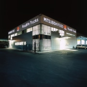 Exterior night view of Roadlife Trucks building, with architecture, building, commercial building, metropolitan area, night, structure, black