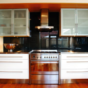 A view of a kitchen, wooden flooring, stainless cabinetry, countertop, cuisine classique, furniture, hardwood, home appliance, interior design, kitchen, kitchen stove, room, white