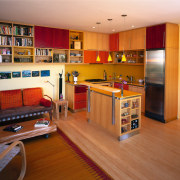 A view of the kitchen and living area, floor, flooring, hardwood, home, interior design, living room, room, wood, brown, orange