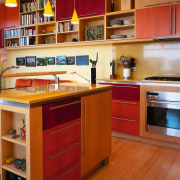 A view of the kitchen area, wooden flooring cabinetry, countertop, cuisine classique, hardwood, interior design, kitchen, room, shelf, shelving, wood, brown, orange