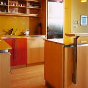 A view of a kitchen, wooden flooring and cabinetry, countertop, floor, flooring, hardwood, interior design, kitchen, room, wood, wood flooring, brown, orange