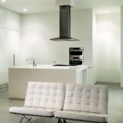 in part, the white minamalist design was inspired chair, couch, floor, furniture, home, interior design, living room, product design, table, wall, gray