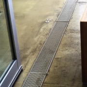 Stainless steel grating in floor of kitchen. - floor, line, metal, steel, orange