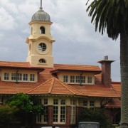 Exterior view of historic building with cream cladding, building, estate, facade, home, house, mansion, outdoor structure, real estate, roof, sky, gray, black