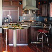 view of this kitchen featuring a cook-n-dine stainless cabinetry, countertop, cuisine classique, floor, flooring, hardwood, interior design, kitchen, laminate flooring, room, wood, wood flooring, black