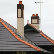 view of the ceramic tiles from nu-lok roofing building, chimney, facade, roof, sky, white, gray
