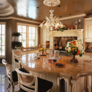 view of the kitchen featuring anitque cream cabnetry, ceiling, countertop, dining room, estate, furniture, home, interior design, kitchen, living room, room, table, brown