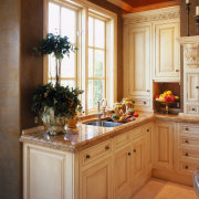 view of the antique cream kitchen cabinetry with cabinetry, countertop, cuisine classique, furniture, home, interior design, kitchen, room, brown