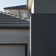 A close up view of the grey roofing. architecture, building, daylighting, facade, home, house, real estate, roof, siding, window, black, gray