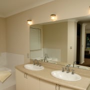 Bathroom with cream walls, twin vanity, large mirror bathroom, floor, home, interior design, property, real estate, room, sink, wall, window, orange, brown