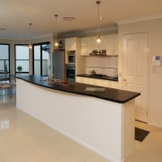 Kitchen with long island bench and brushed chrome cabinetry, countertop, cuisine classique, floor, flooring, interior design, kitchen, property, real estate, room, orange, gray