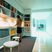 A view of one of the mini libraries architecture, ceiling, daylighting, floor, furniture, house, interior design, table, teal