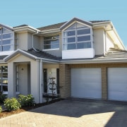 An exterior view of the house, brick driveway, building, elevation, estate, facade, home, house, property, real estate, residential area, siding, window, gray