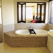 A view of a bathroom, cream tiled floor, bathroom, floor, interior design, real estate, room, suite, brown, white