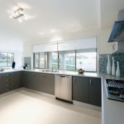 view of the bright open kitchen featuring modern countertop, cuisine classique, daylighting, interior design, kitchen, property, real estate, room, window, white