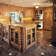 A view of a kitchen, brown and white cabinetry, countertop, cuisine classique, flooring, kitchen, room, orange, black, brown