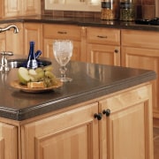 A viewof a kitchen, grey benchtops, stainless steel cabinetry, countertop, cuisine classique, drawer, floor, flooring, furniture, hardwood, kitchen, table, wood flooring, wood stain, orange, brown