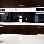 A close up view of the wooden cabinetry cabinetry, countertop, furniture, interior design, kitchen, product design, black, white