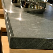view of this  granite countertop  by countertop, floor, flooring, furniture, material, table, brown