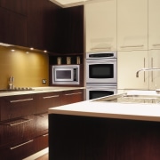 view of this kitchen featuring dcs stainless steel cabinetry, countertop, cuisine classique, home appliance, interior design, kitchen, room, under cabinet lighting, black, orange