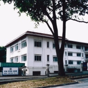 A view of the apartments before they were building, facade, home, house, property, real estate, tree, white, black