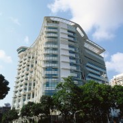 Exterior view of the 16-storey Library and theatre apartment, architecture, building, city, commercial building, condominium, corporate headquarters, daytime, downtown, facade, headquarters, hotel, metropolis, metropolitan area, mixed use, neighbourhood, palm tree, real estate, residential area, sky, skyscraper, tower block, urban area, white