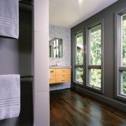 the large bathrom is divided into zones, a ceiling, door, floor, flooring, home, house, interior design, real estate, room, wall, window, wood, wood flooring, gray, black