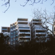 Exterior view of new apartment complex in Sydney. architecture, building, condominium, facade, home, house, residential area, sky, tree, black, white