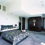 A view of a bedroom, grey carpet, white architecture, bed frame, bedroom, ceiling, floor, flooring, interior design, property, real estate, room, suite, white