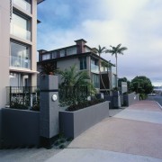 An exterior view of the entrance to the apartment, arecales, building, condominium, facade, home, house, neighbourhood, palm tree, property, real estate, residential area, window, gray, black