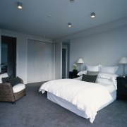 A view of a bedroom, white walls and architecture, bed frame, bedroom, ceiling, floor, home, interior design, lighting, real estate, room, wall, window, gray