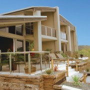 A exterior view of a holiday home. - cottage, elevation, facade, home, house, property, real estate, residential area, siding, villa, brown