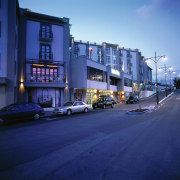 An exterior viewof the Soffitel hotel in Queenstown. architecture, building, car, city, downtown, evening, facade, family car, home, house, infrastructure, metropolitan area, mixed use, neighbourhood, night, real estate, residential area, road, sky, street, suburb, town, urban area, window, blue, teal