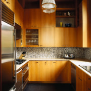 The homes remodled kitchen with new brown cabinetry. cabinetry, ceiling, countertop, cuisine classique, flooring, hardwood, home, interior design, kitchen, lighting, real estate, room, under cabinet lighting, wood, brown, black