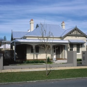 Exterior view of home and front veranda. - architecture, building, cottage, estate, facade, home, house, mansion, neighbourhood, property, real estate, residential area, roof, sky, suburb, teal