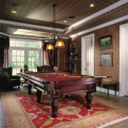 A  view of the games rooms, tiled billiard room, billiard table, ceiling, floor, flooring, furniture, hardwood, interior design, pool, recreation room, room, table, wood, black