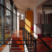 A view of a hallway, wooden flooring, large apartment, architecture, condominium, estate, facade, floor, flooring, handrail, house, interior design, lobby, loft, property, real estate, stairs, wall, window, black, brown