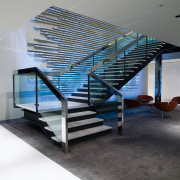 A view of a glass staircase. - A architecture, ceiling, condominium, daylighting, glass, handrail, interior design, real estate, stairs, gray, black