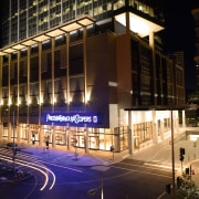 An exterior view of the Freshwater Place building. architecture, building, city, commercial building, condominium, convention center, corporate headquarters, downtown, facade, headquarters, landmark, metropolis, metropolitan area, mixed use, night, skyscraper, structure, urban area, black