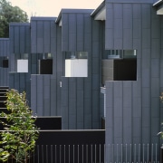 A exterior view of the material used on architecture, building, facade, fence, gate, home, house, real estate, residential area, shed, siding, black, gray