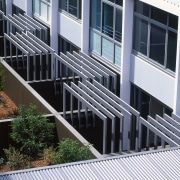A view of some louvres. - A view architecture, building, condominium, facade, handrail, house, mixed use, real estate, residential area, siding, window, black, gray