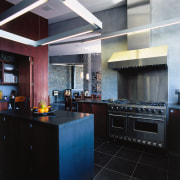 view of the kitchen featuring stainless oven, rangehood, countertop, interior design, kitchen, black, gray