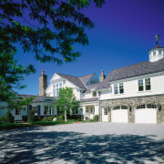 Exterior view of large home with white cladding, building, estate, facade, home, house, mansion, property, real estate, residential area, sky, tree, blue