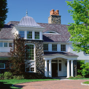 Exterior view of home entranceway with columns, white architecture, building, cottage, elevation, estate, facade, farmhouse, historic house, home, house, landmark, landscaping, mansion, neighbourhood, outdoor structure, property, real estate, residential area, roof, siding, suburb, tree, window, blue