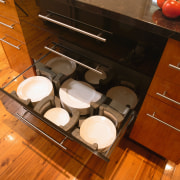 Kitchen with view of island drawers. - Kitchen cabinetry, countertop, drawer, floor, flooring, furniture, hardwood, kitchen, kitchen organizer, room, table, wood, brown, orange