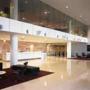 view of the central double heigt atrium featuring ceiling, floor, flooring, interior design, lobby, gray